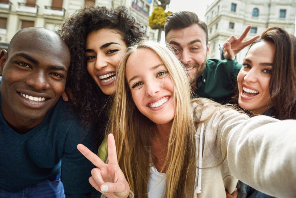 multiracial group young people taking selfie